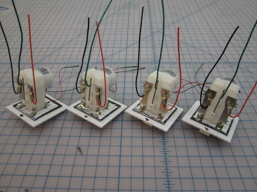 The four assembled and tested Mole Switch Machines for the staging yard.